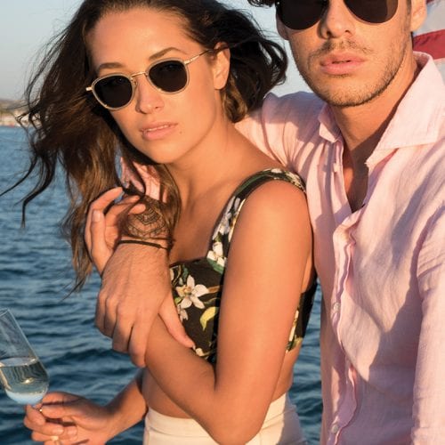 Couple wearing sunglasses on a boat